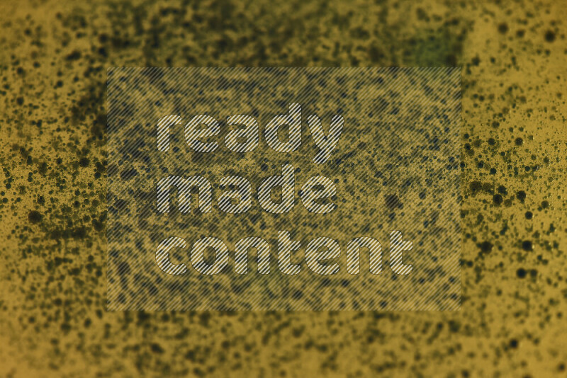 Close-ups of abstract green watercolor drops on oil Surface on yellow background