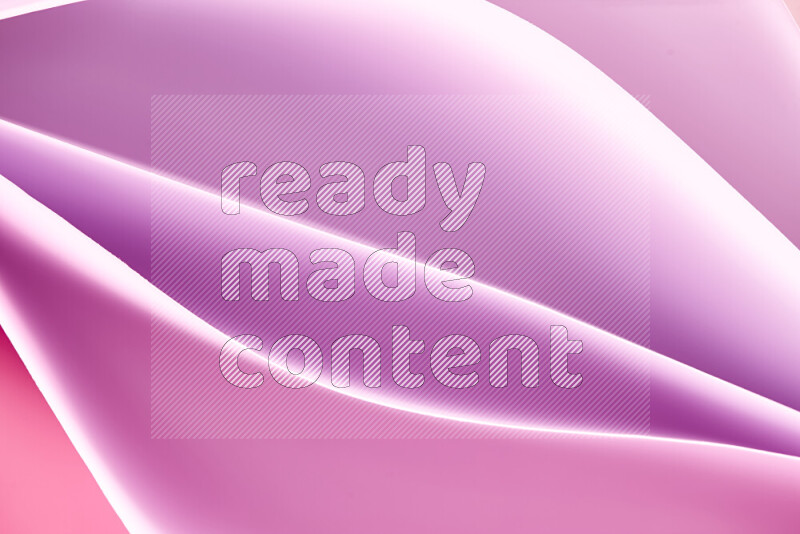 This image showcases an abstract paper art composition with paper curves in purple and pink gradients created by colored light