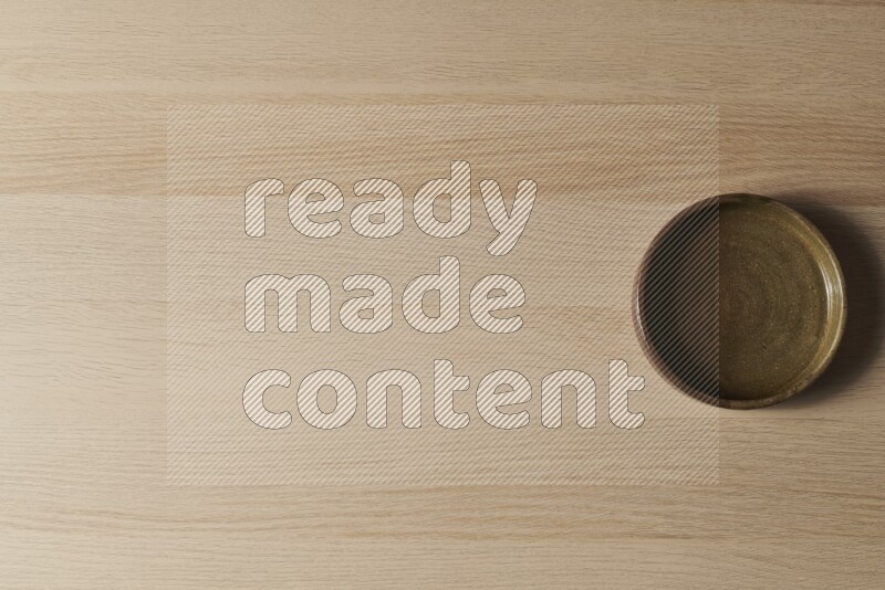 A multicolored pottery oven plate on light wooden background