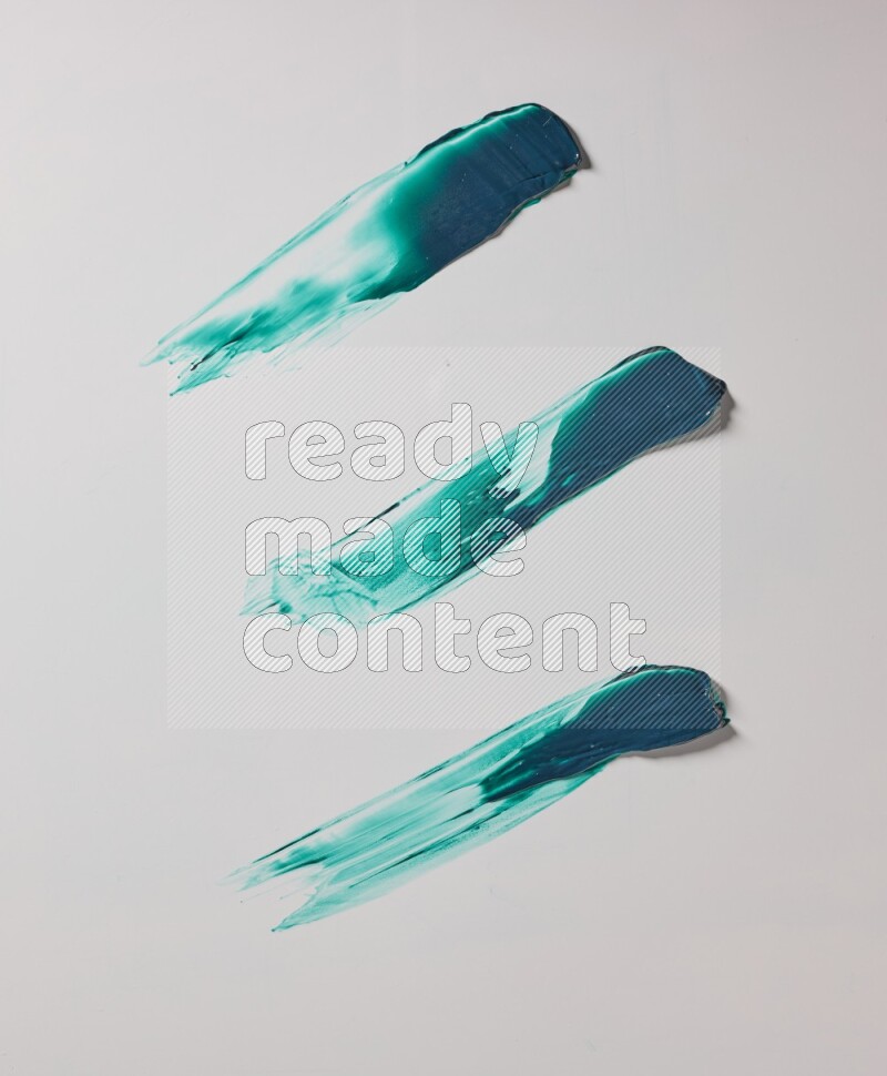 Turquoise painting knife strokes on white background