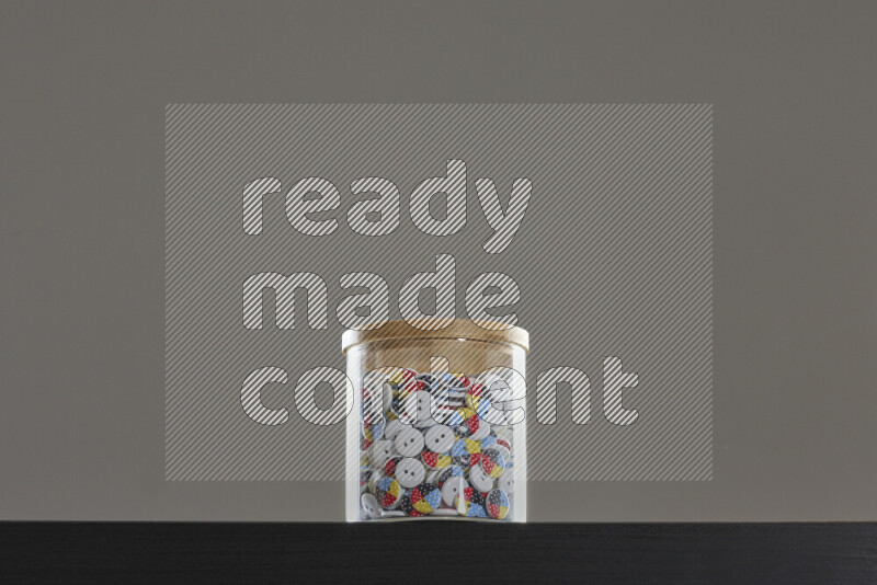 Buttons in a glass jar on black background