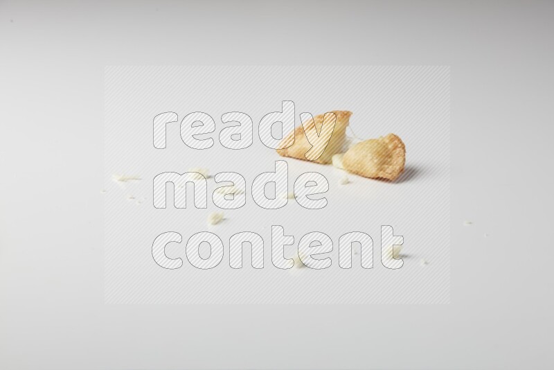 One cheese sambosa cut in half on a white background