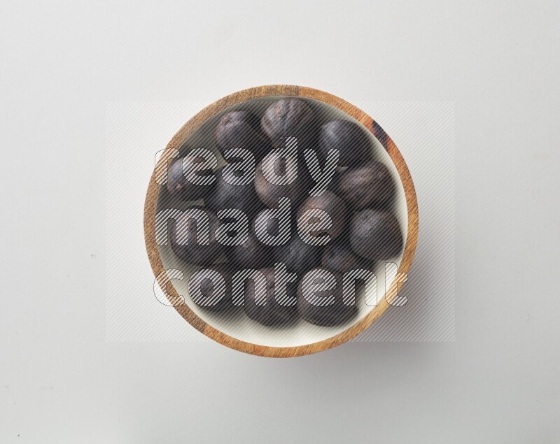 Top-view shot of dried lime (loomi) in a container on white background