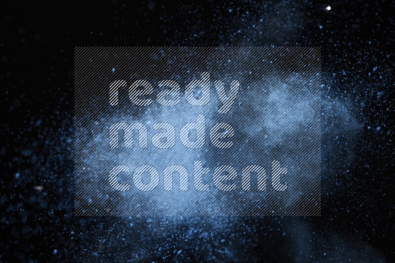 Blue powder explosion on black background