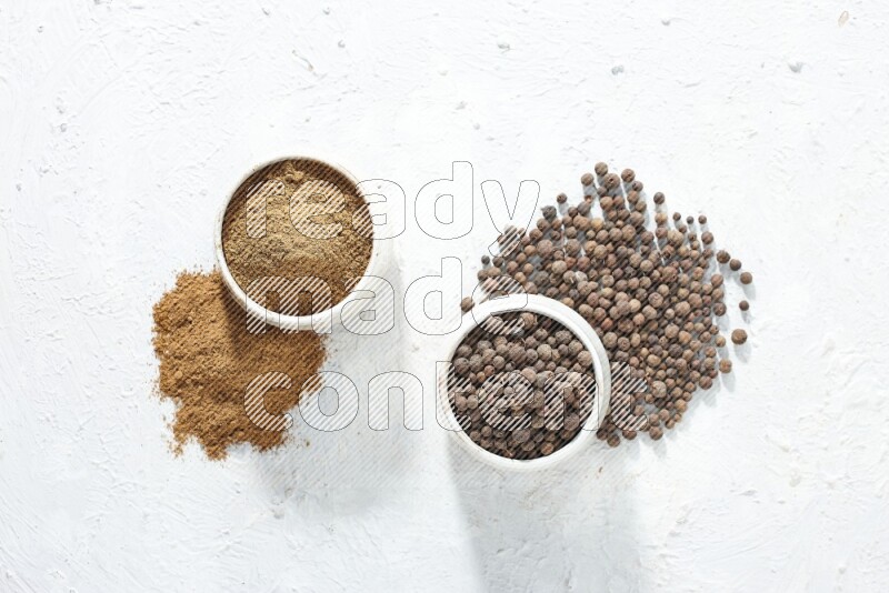 2 beige bowls, one full of powder and the other full of whole balls with balls and powder spreaded on a textured white flooring