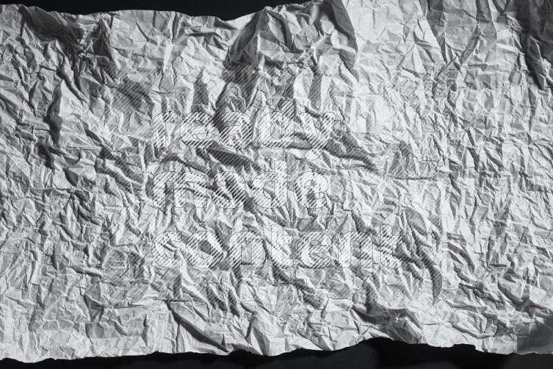 White paper sheet on black background