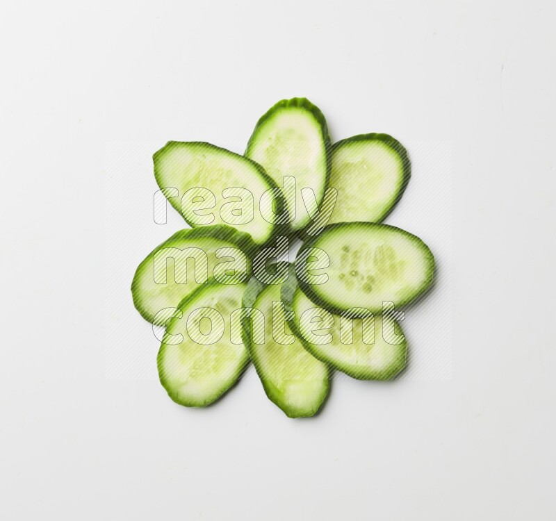 Multiple cucumber slices on white background