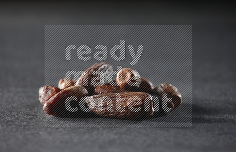 Dried dates on a black background in different angles