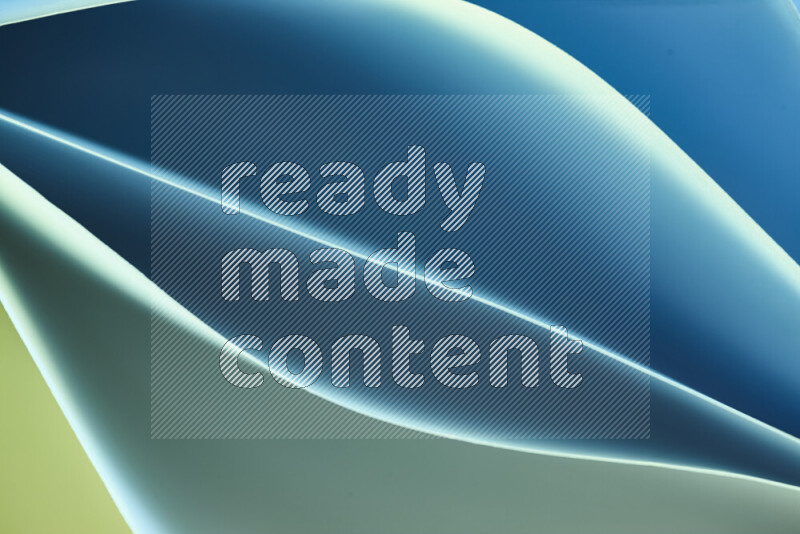 هذه الصورة تعرض تكوين فن الورق التجريدي مع منحنيات ورقية بتدرجات اللون الأخضر والأزرق المكونه بواسطة الضوء الملون