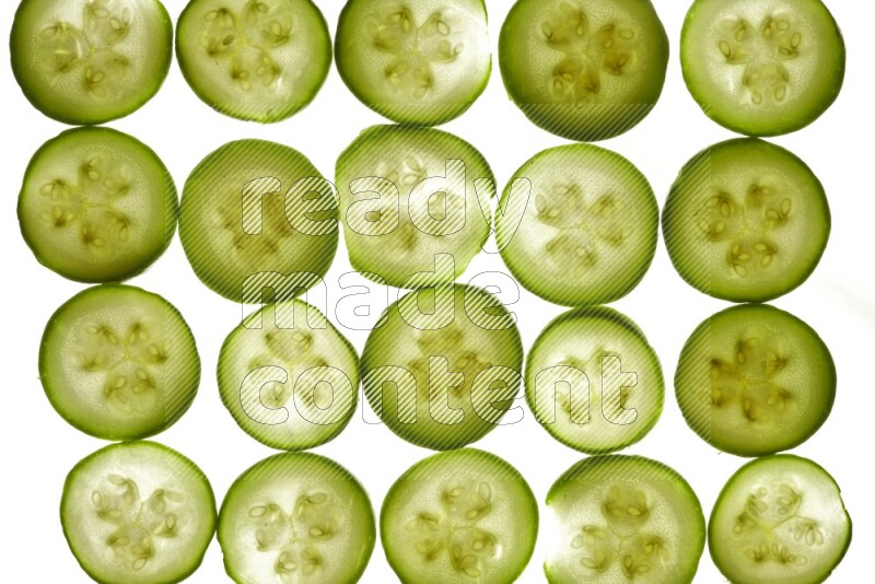 Zucchini slices on illuminated white background
