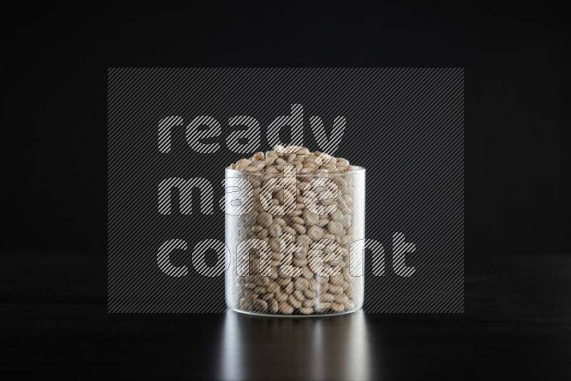 Lupin Beans in a glass jar on black background
