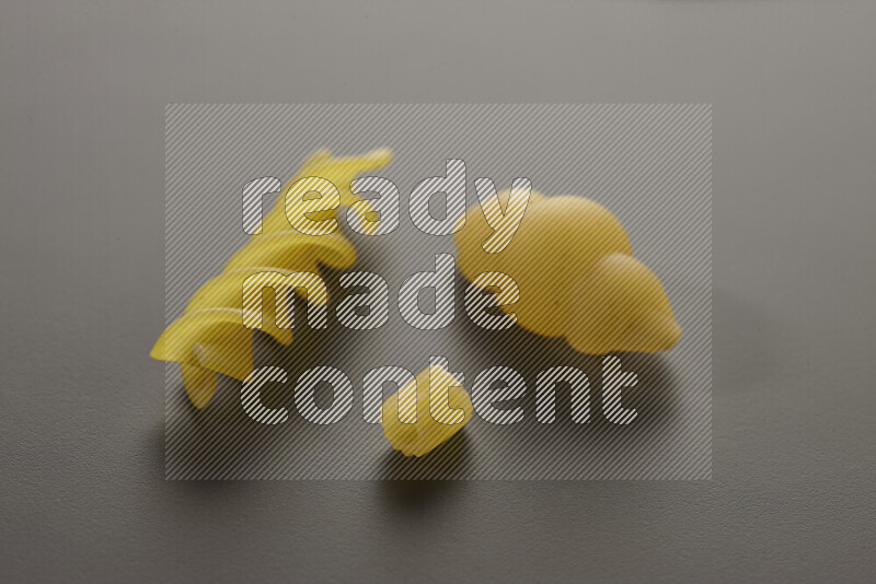 Different pasta types on grey background