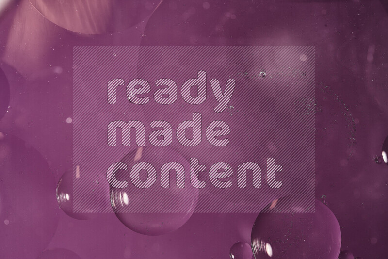 Close-ups of abstract oil bubbles on water surface in shades of purple