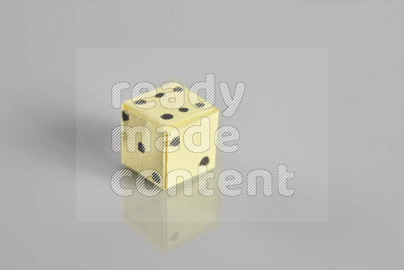 Origami dice on grey background