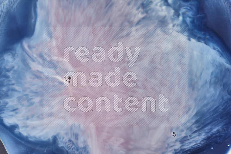 A close-up of abstract swirling patterns in blue, red and white