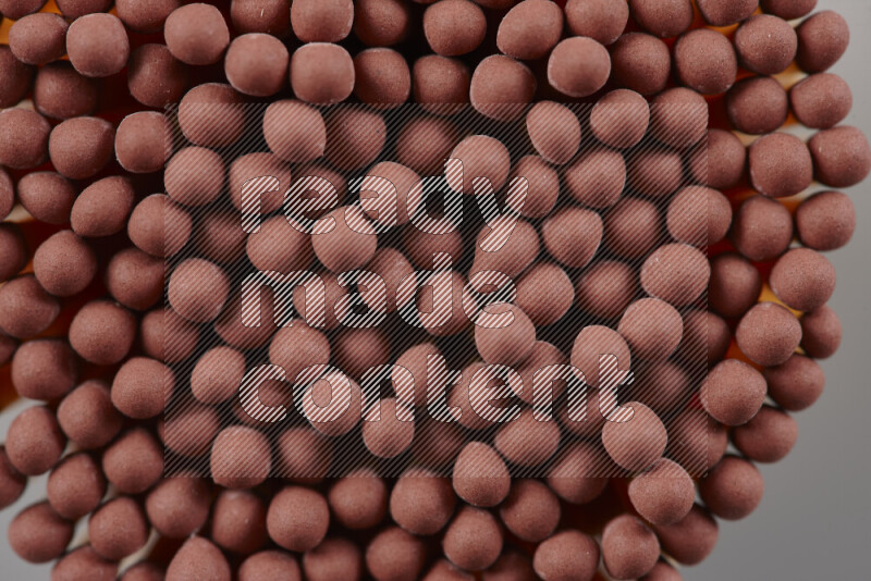A close-up of a bundle of matches on grey background