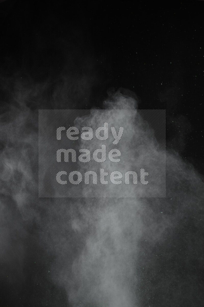 A side view of green powder explosion on black background