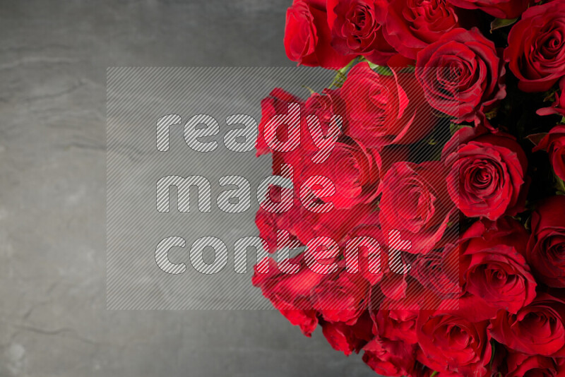A luxurious bouquet of red roses on black marble background