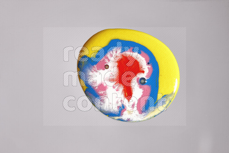 Close-ups of assorted colors blending on a grey background