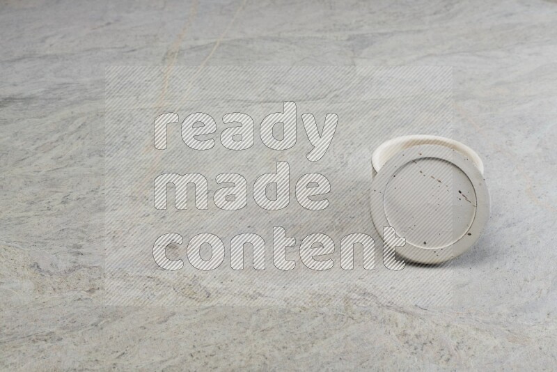 A white pottery bowl on grey marble background