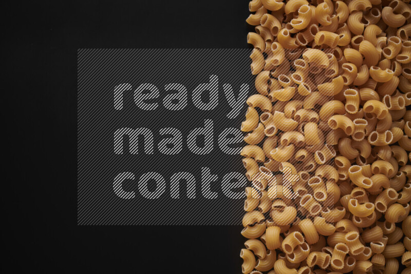 Different pasta types on black background