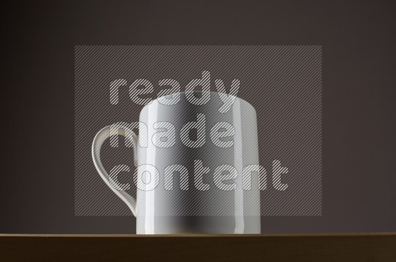 Low angle shot of a white cup on grey background