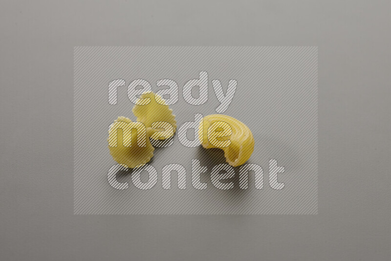 Fiocchi pasta with other types of pasta on grey background