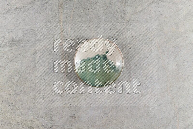 A multicolored pottery Bowl on grey marble background