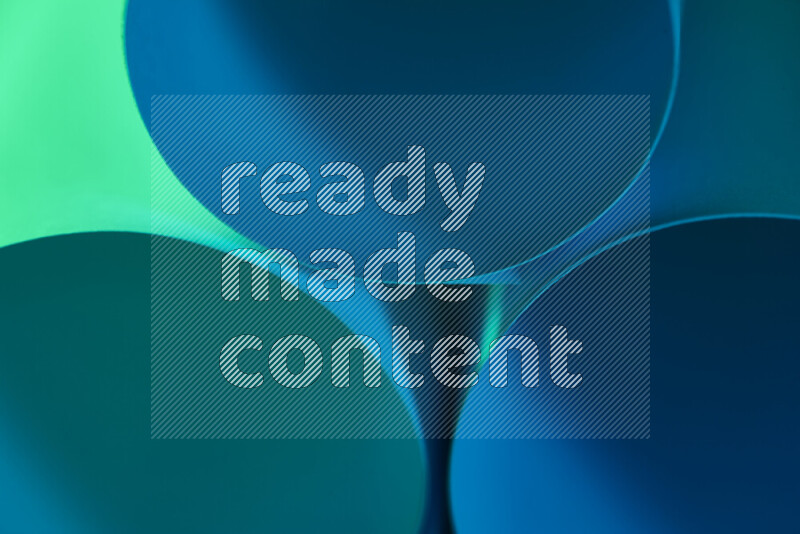 The image shows an abstract paper art with circular shapes in varying shades of green and blue