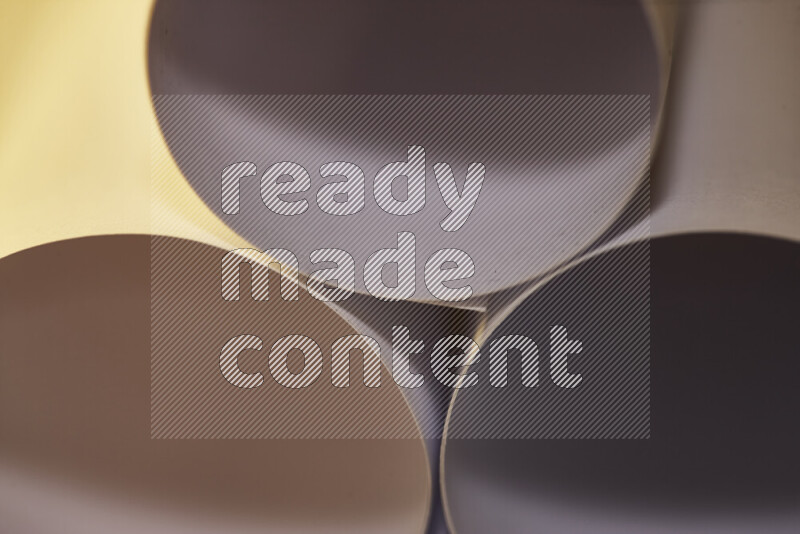 The image shows an abstract paper art with circular shapes in varying shades of grey and warm tones