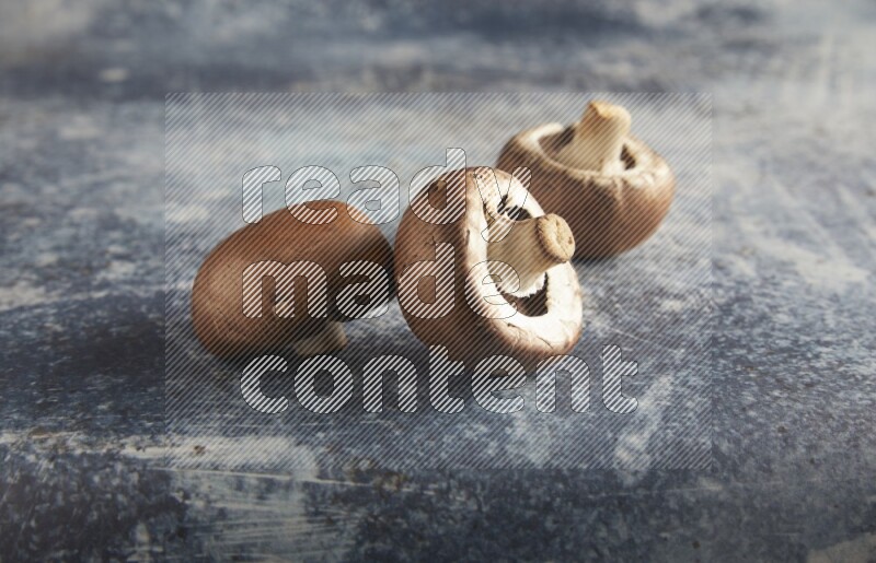 45 degre cremini  mushrooms on a textured rustic blue background