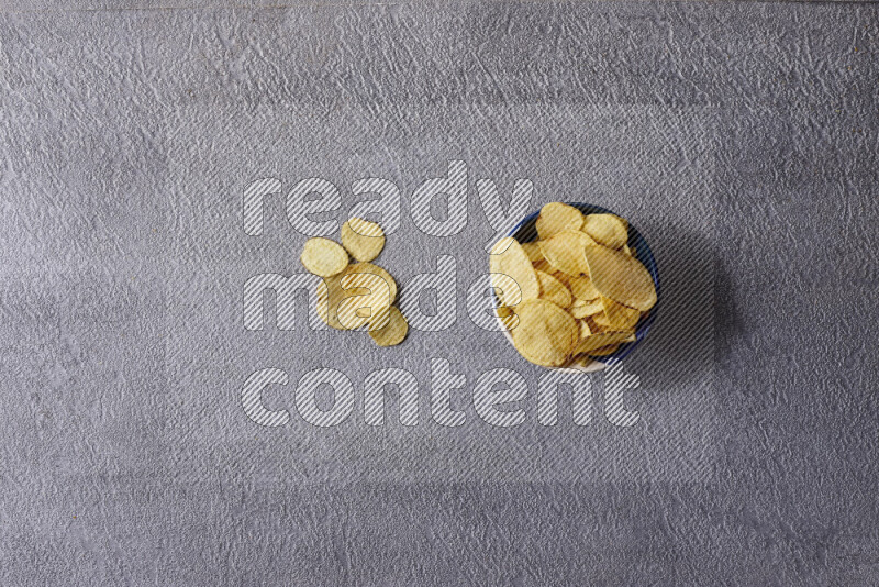 Assorted snacks in pottery bowls on grey background