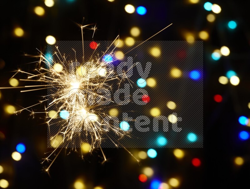 Sparkler candles with multicolored light bokeh background