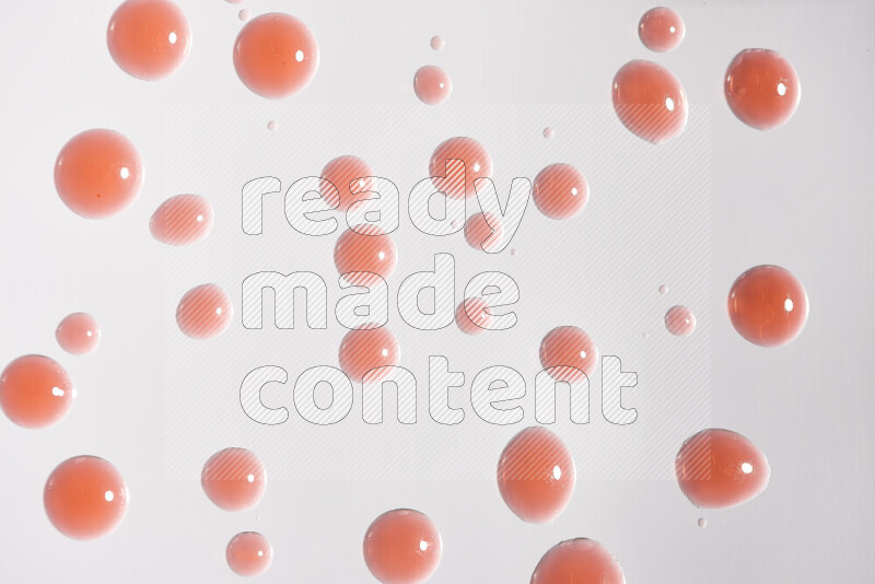 Close-ups of abstract red paint droplets on white background