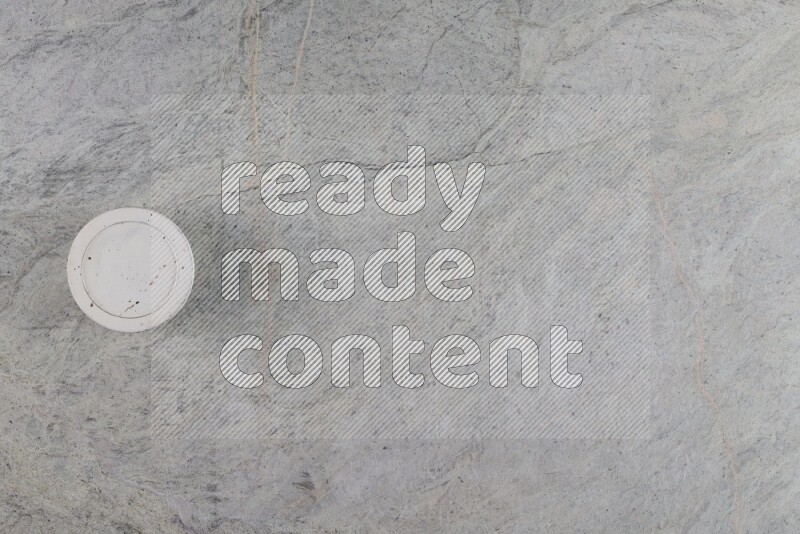 A multicolored pottery Cup on grey marble background