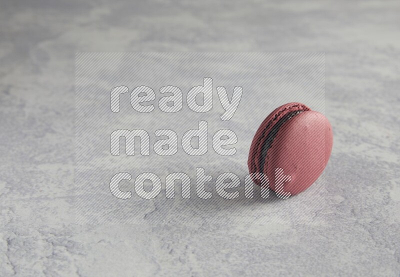 45º Shot of Red Cherry macaron on white  marble background