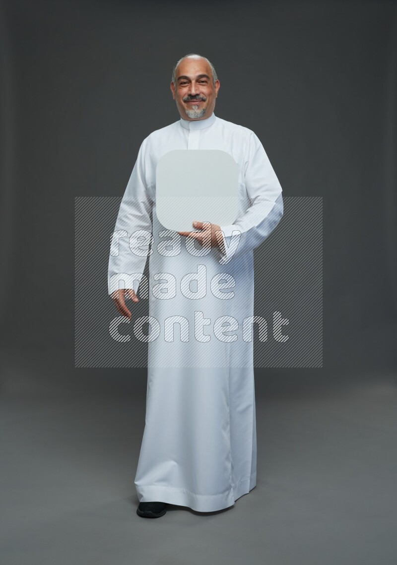 Saudi man without shomag Standing holding social media sing on gray background