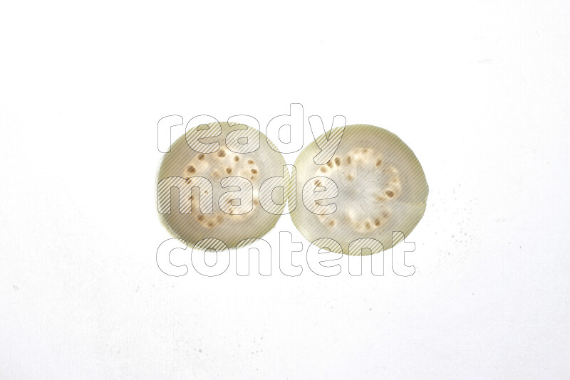 Guava slices on illuminated white background