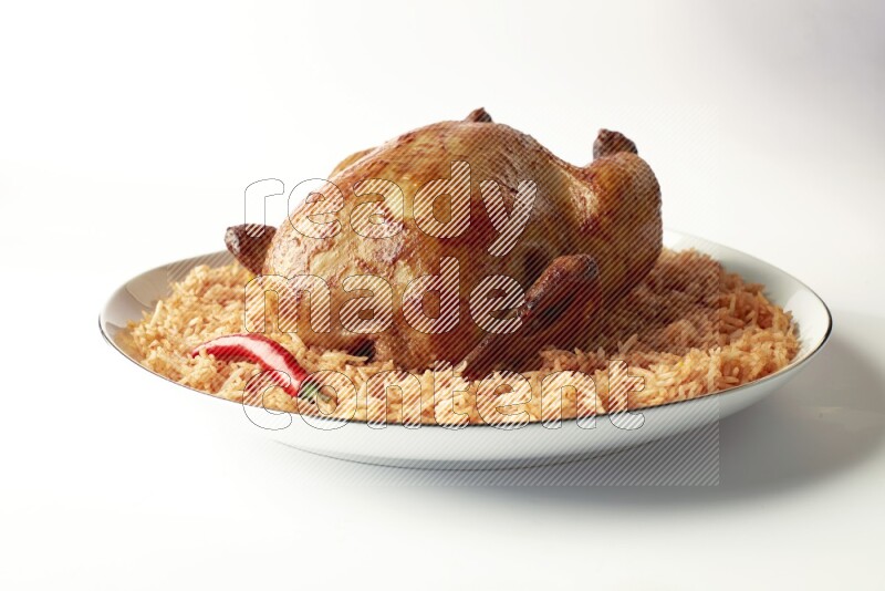 red basmati Rice with whole roasted chicken on a white plate with a silver rim direct on white background
