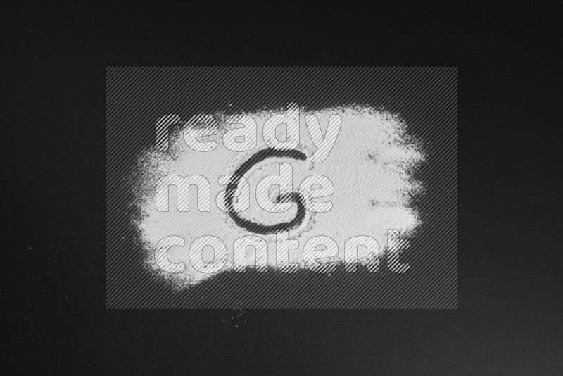 Alphabets written with powder on black background