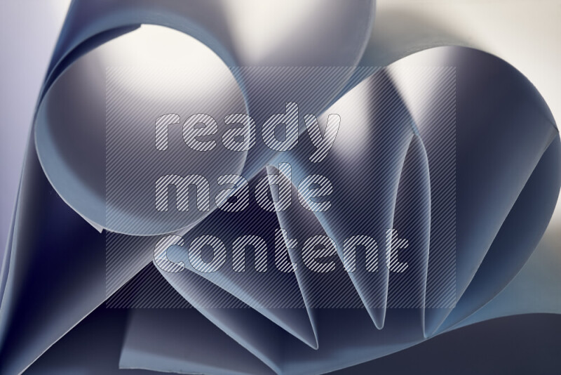 An artistic display of paper folds creating a harmonious blend of geometric shapes, highlighted by soft lighting in blue tones