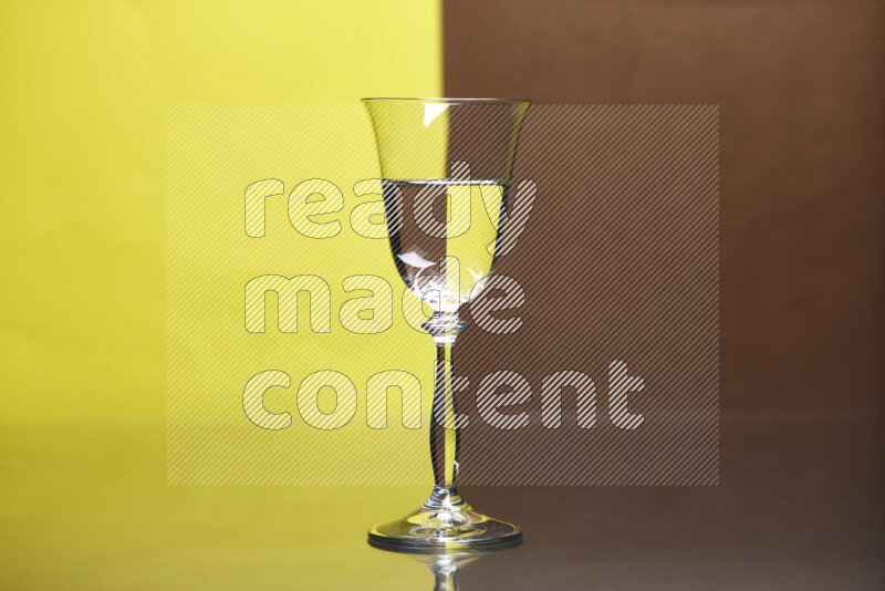 The image features a clear glassware filled with water, set against yellow and brown background