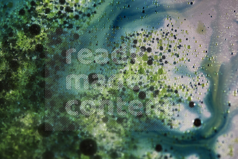 Close-ups of abstract green and blue watercolor drops on oil Surface on white background