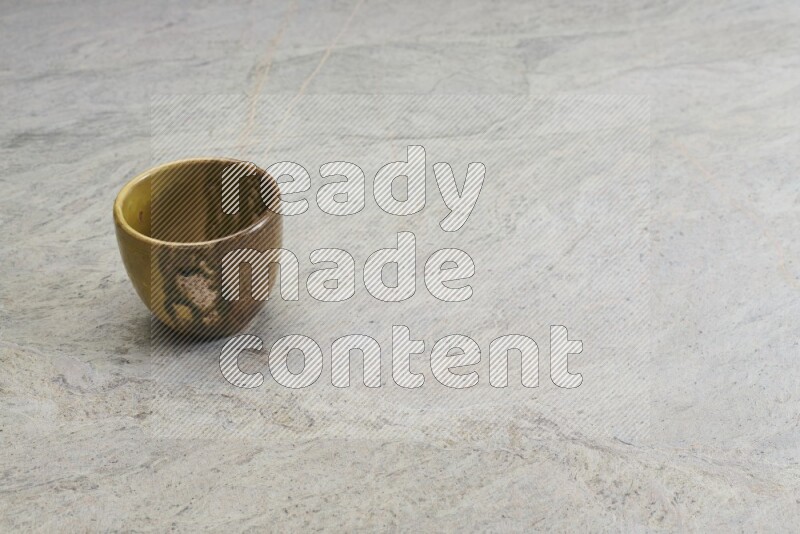 A multicolored pottery Cup on grey marble background