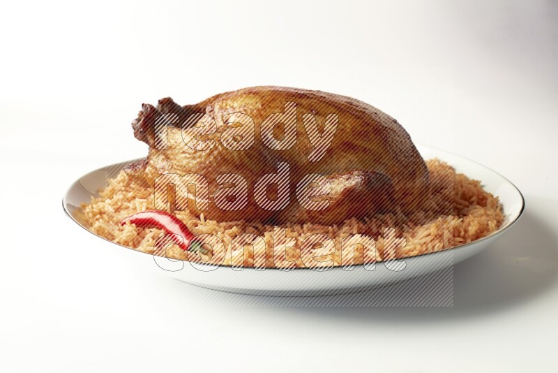 red basmati Rice with whole roasted chicken on a white plate with a silver rim direct on white background