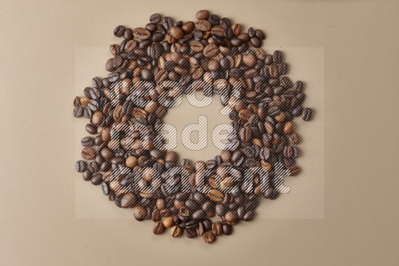 Roasted coffee beans on beige background