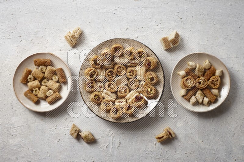 Oriental sweets in pottery plates in a light setup