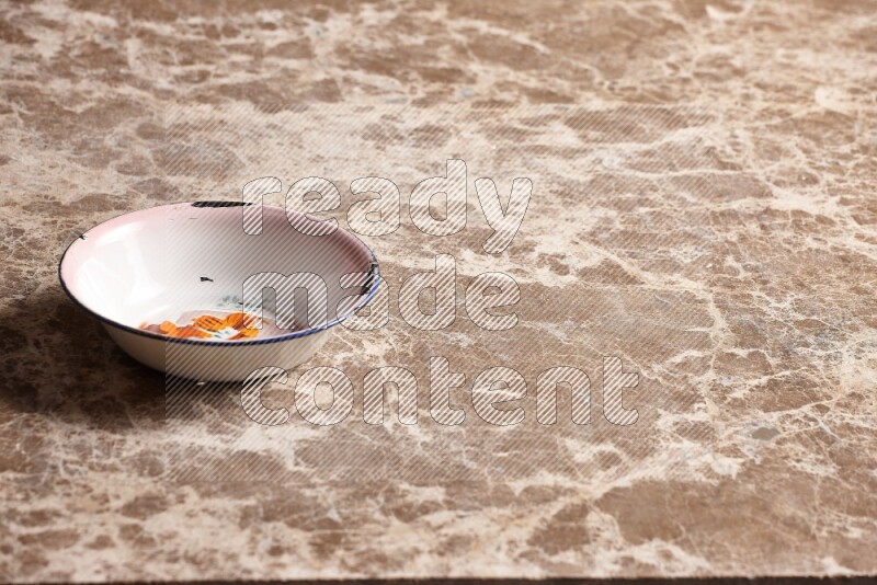 A vintage metal plate on beige marble background