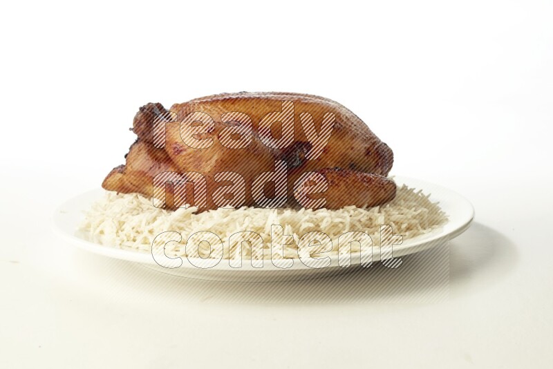 white  basmati Rice with  whole roasted chicken  on a white rounded plate direct on white background
