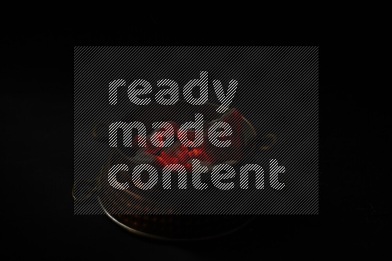 Coal cubes on fire in metal pan